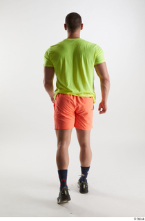 Joel  1 back view dressed green sneakers orange shorts…